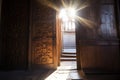 sunlight filtering through an elaborately carved wooden church door