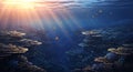Sunlight filtering through ocean surface onto vibrant coral reef teeming with small fish Royalty Free Stock Photo