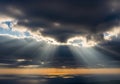 Sunlight filters through thick, dark clouds, Royalty Free Stock Photo