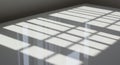 Sunlight filters through a window, casting geometric shadows of window bars on a Royalty Free Stock Photo