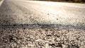 Sunlit asphalt texture creates a path forward, representing journeys and new beginnings Royalty Free Stock Photo
