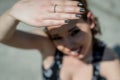 Sunlight hand protection. Young woman covering with hand`s shadow the eyes to avoid sunlight.