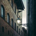 Sunlight hits a vintage lamp post of the public lighting in Florence