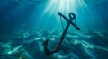 Sunlight illuminates an anchor on the ocean floor of the deep sea Royalty Free Stock Photo