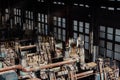 Sunlight illuminating old steel forming machinery inside a windowed warehouse