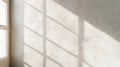 Sunlight illuminating white textured wall through window frame, creating an abstract pattern of light and shadow Royalty Free Stock Photo
