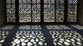 Sunlight patterns cast on floor from ornate window with geometric designs in a bright room Royalty Free Stock Photo