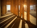 Sunlight peeking between wood studs inside a new home under construction
