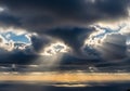 Sunlight pierces through dense, dark clouds, Royalty Free Stock Photo