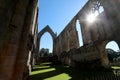 20 September 2021: Sunlight pierces the ruins of Bolton Priory, North Yorkshire