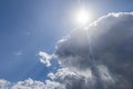 Sunlight piercing cumulus clouds against a vivid blue sky for creative backdrops Royalty Free Stock Photo