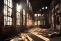 sunlight piercing through broken windows in an old factory Royalty Free Stock Photo