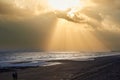 Sunlight rays bursting through the clouds on to the sea below Royalty Free Stock Photo