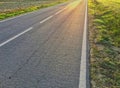 Sunlight reflected off asphalt, straight road leading into the distance Royalty Free Stock Photo