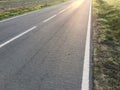 Sunlight reflected off asphalt, straight road leading into the distance Royalty Free Stock Photo