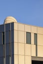 Sunlight reflection on surface of modern building wall with ventilation chimney against blue clear sky background Royalty Free Stock Photo