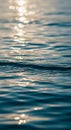 Sunlight reflects off gently rippled water, creating a pattern of shimmering highlights. The Royalty Free Stock Photo