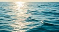 Sunlight reflects on a serene ocean surface, casting a bright, shimmering path across gentle waves. Royalty Free Stock Photo
