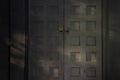 Sunlight and shadow on grey and grunge wooden door