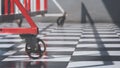 Low section of red barrier on chessboard pattern of tile floor in auto accessories workshop area