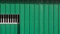 Sunlight and shadow on surface of sliding entrance door on green corrugated steel wall background Royalty Free Stock Photo