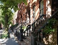 Sunlight shines on a block of historic brownstone buildings in the East Village neighborhood of Manhattan in New York City Royalty Free Stock Photo