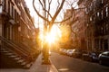 Sunlight shines on a block of historic brownstone buildings on Perry Street in the West Village neighborhood of New York City Royalty Free Stock Photo