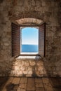 Sunlight shines through the open window overlooking the sea. Royalty Free Stock Photo