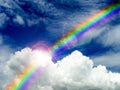 sunlight shining on cloud and rainbow after rain fall