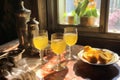 sunlight shining through limoncello-filled glasses on a table