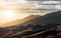 Sunlight shining over Great Sand Dunes National Park in the Colorado Rocky Mountains Royalty Free Stock Photo