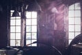 Sunlight shining through the windows of an old abandoned industrial warehouse building Royalty Free Stock Photo