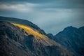 Sunlight Spills Over a Cliff In The Tundra Of Rocky Mountain