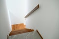 Sunlight on staircase wooden with wooden handrails on white wall in modern home from above. Interior structure design concept. Royalty Free Stock Photo