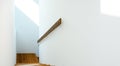 Sunlight on staircase wooden with wooden handrails on white wall in modern home from above. Interior structure design concept. Royalty Free Stock Photo