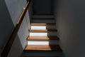 Sunlight on staircase wooden with wooden handrails on white wall in modern home. Interior structure design concept. Empty pathway Royalty Free Stock Photo