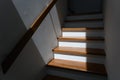 Sunlight on staircase wooden with wooden handrails on white wall in modern home. Interior structure design concept. Empty pathway Royalty Free Stock Photo