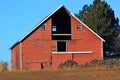 Red Barn with hay loft door missing Royalty Free Stock Photo