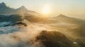 Sunlight streaming through clouds on mountainous landscape