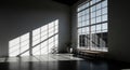 Sunlight streaming through large industrial windows illuminating an empty spacious room casting dramatic shadows Royalty Free Stock Photo