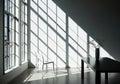 Sunlight streaming through large windows casting dramatic geometric shadows on the floor and wall of an empty room creating a Royalty Free Stock Photo
