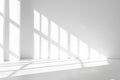 Sunlight streaming through large windows creates geometric shadows on white walls and floor Royalty Free Stock Photo