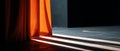 Sunlight streaming through partially open orange curtain casting long shadows on dark floor in minimalist interior space Royalty Free Stock Photo