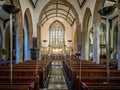 Sunlight streaming through stained galss window with reflection on floor in St Peters Church, Dorchester, Dorset