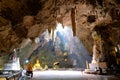 Sunlight streaming into the Tham Khao Luang cave from a ceiling opening, illuminating the large cavern temple, Phetchaburi Royalty Free Stock Photo