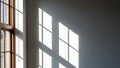 Sunlight streaming through a window casting geometric shadows on a wall Royalty Free Stock Photo