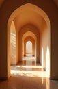 Sunlight streams through arched hallway casting geometric shadows on tiled floor. Corridor creates sense of depth perspective, Royalty Free Stock Photo