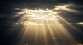 Sunlight streams through gaps in dark, dense clouds, creating striking beams