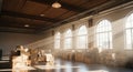 Sunbeams Streaming Through Arched Windows Illuminating a Warehouse Filled with Cardboard Boxes storage Royalty Free Stock Photo