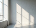 Sunlight streams through large window, casting geometric shadows on textured wall. Clean empty room interior offers space for Royalty Free Stock Photo